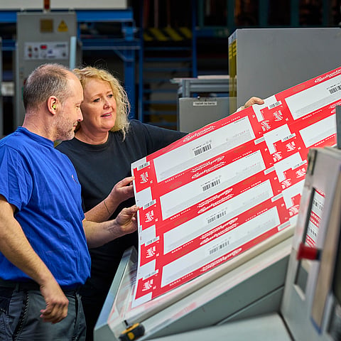 male and female worker checking product quality