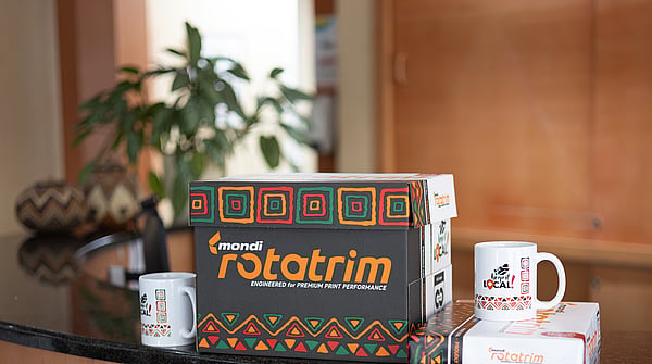 box of Mondi Rotarim paper on a table with white mugs either side of the box