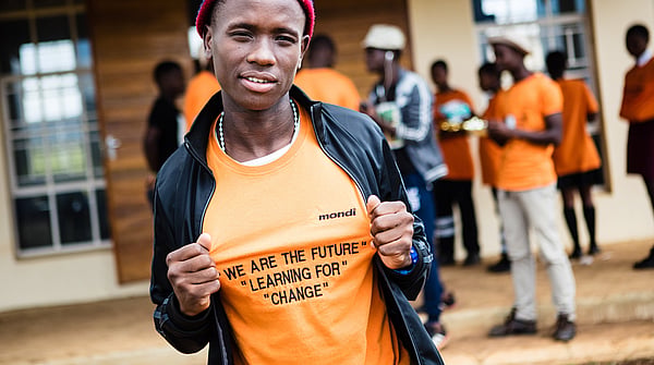 Person holding their t-shirt in a confident pose.