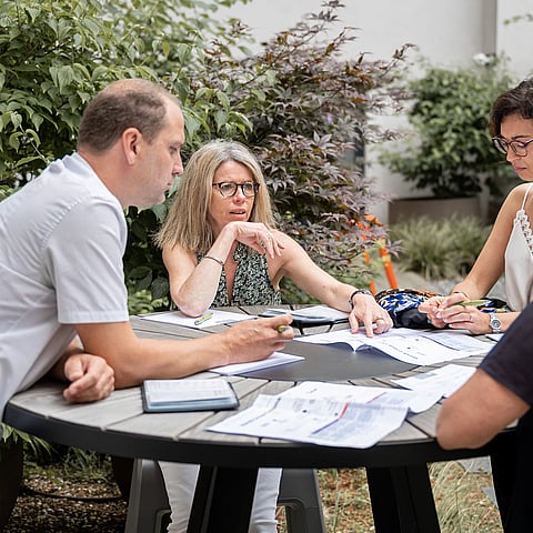 colleagues brainstorming outside the meeting room