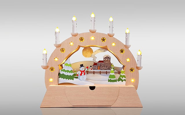 The image displays an example of intricate die-cutting technology: a Christmas arch decorated with lights.