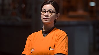 Image of Melike a female process engineer in Mondi Tire in Türkiye wearing an orange t-shirt and glasses