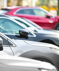A close-up view of cars parked in a row.