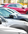 A close-up view of cars parked in a row.