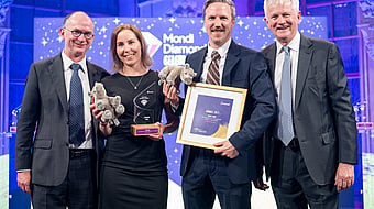 Photograph from Mondi’s Diamond Awards showing Mondi's executive with the winners, holding the award and a certificate.