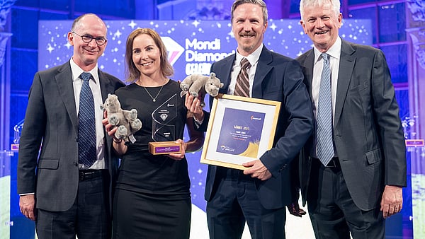 Photograph from Mondi’s Diamond Awards showing Mondi's executive with the winners, holding the award and a certificate.