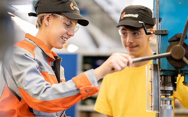 Two colleagues discussing on a forklift truck