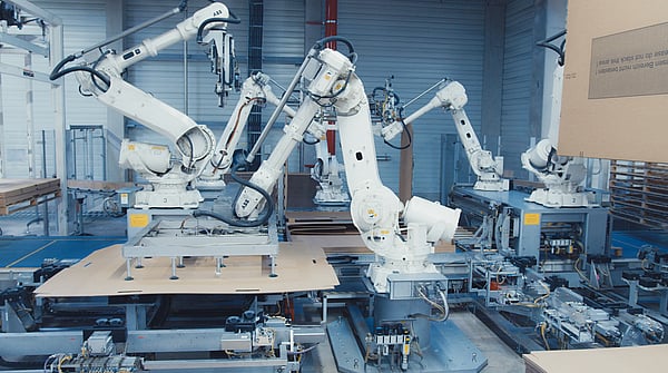 heavy-duty corrugated packaging machinery being used at a factory to create corrugated packaging