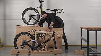 A man is removing the bike packaging made by Mondi.