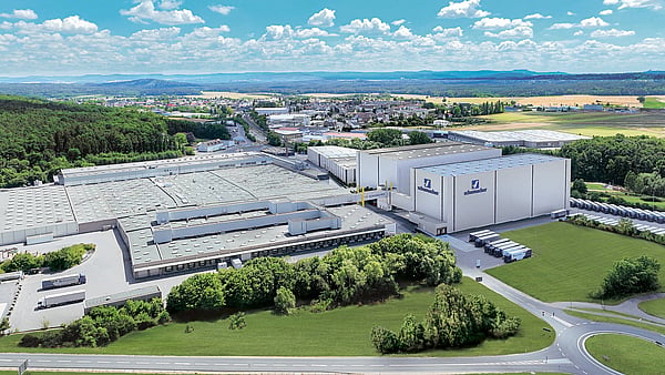 Aerial shot of Schumacher packaging western Europe operations building surrounded by trees and roads.