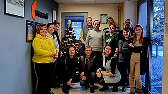 Mondi colleagues gathered together next to a Christmas tree to take a photograph.